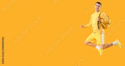 Happy male student with bac...
