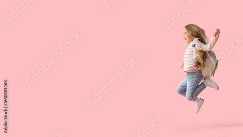 Jumping little schoolgirl w...