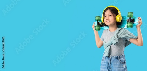 Little Asian girl in headph...