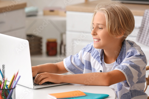Little boy with laptop doin...
