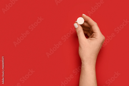 Female hand with pill on re...
