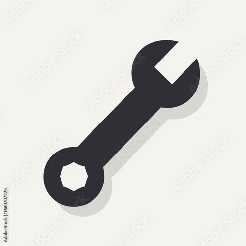 Stylized dark grey combination wrench icon with subtle shadow.