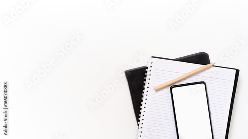 Smart phone, pen, eyeglasses and notepad on white background