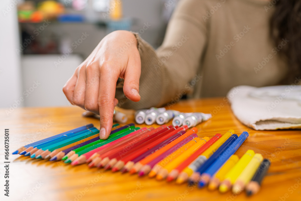 Fototapeta premium Graphic designer choosing colored pencils in home studio