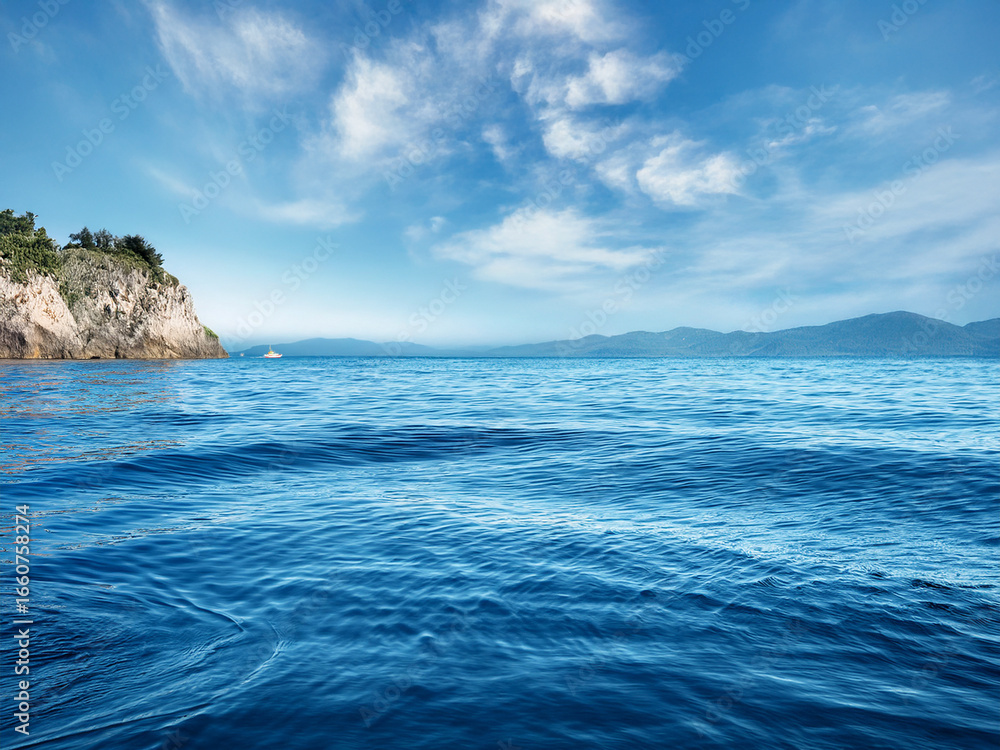 Fototapeta premium 青く広がる海と空、手前の岩場が美しい雄大な自然風景