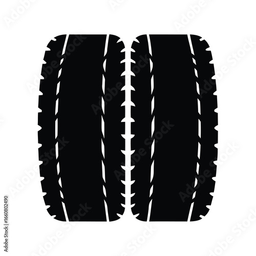 Two bold black car tires with a unique tread design isolated
