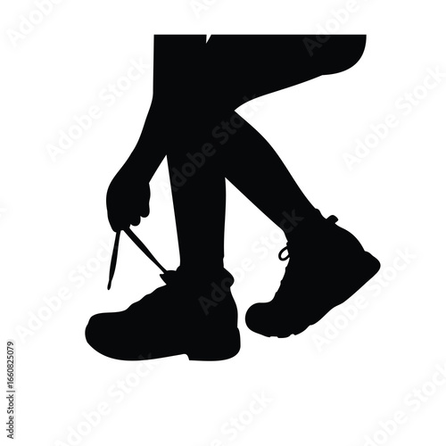 Silhouette of Someone Tying Their Shoe, Getting Ready for a Run
