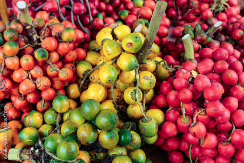 Many fruits of the peach palm, Bactris Gasipaes, a species of multi-stemmed palm tree from the Arecaceae family, a species native to the Amazon region