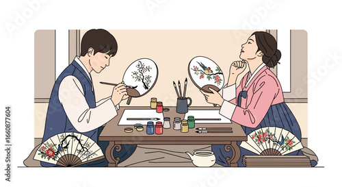 Korean couple in traditional hanbok attire meticulously paint intricate designs onto delicate hand fans.