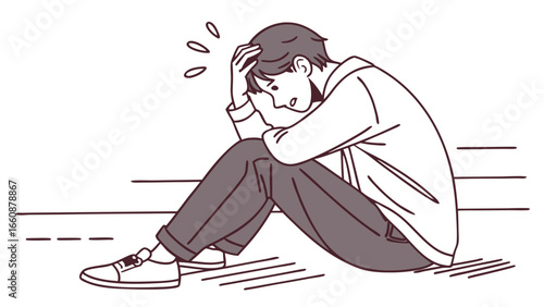 A man sitting on the ground with his head in his hand.