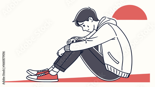 A young man sitting alone feeling sad.