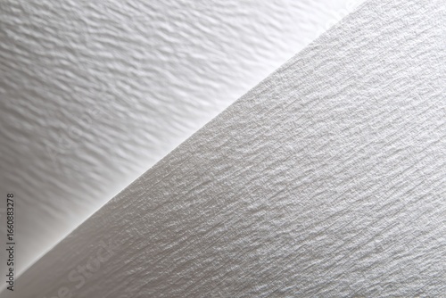 Close-up of two overlapping sheets of textured white material