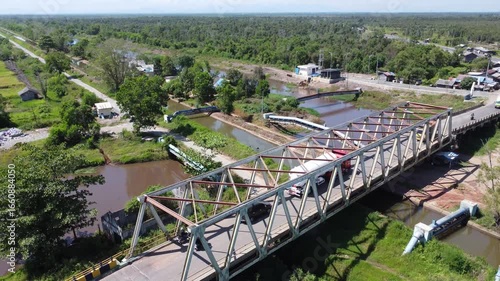Wallpaper Mural Old bridge crossed by many loaded trucks with a road full of holes Torontodigital.ca