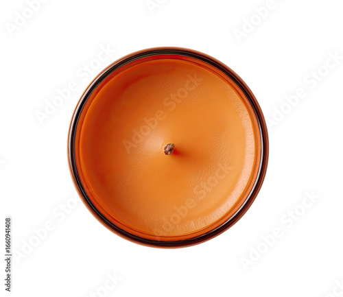 Overhead view of an orange candle.  A round, orange candle with a dark-edged, transparent container.  Small wick visible in the center