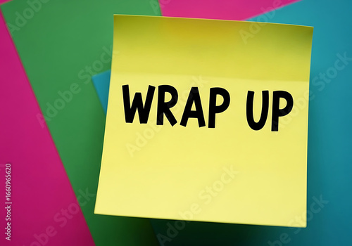 Yellow sticky note with wrap up text on abstract colorful background