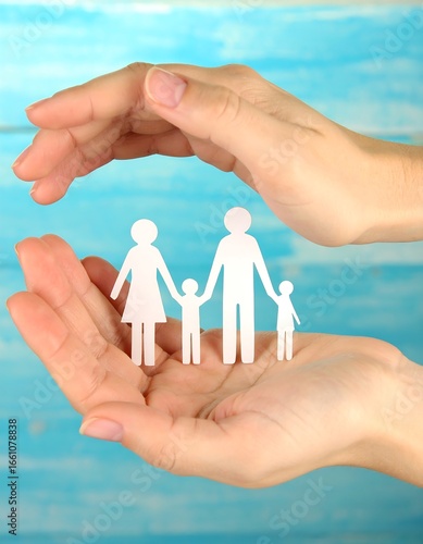 Hands protecting family silhouette
