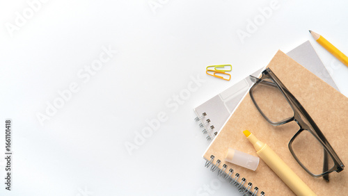 Organized workspace essentials glasses notebook marker pencil paperclips for focused productivity and learning