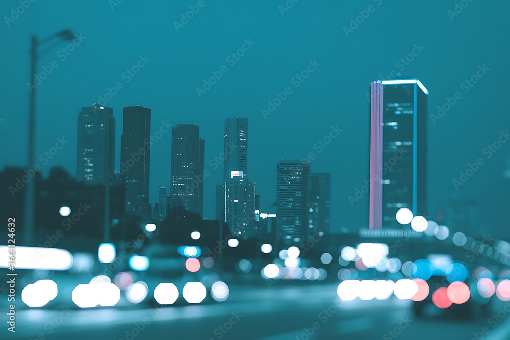 Obraz premium Blurred city lights and skyscrapers at dusk create a vibrant energetic urban atmosphere in this night scene