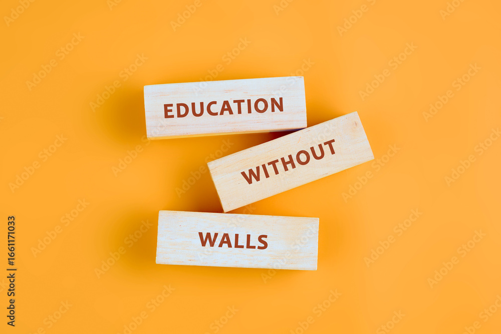 Naklejka premium Copy space; Concept words EDUCATION WITHOUT WALLS assembled from blocks on orange background, top view