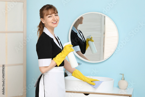 Smiling maid with detergent...