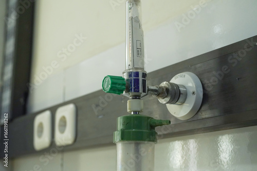close up of medical oxygen regulator installed on the wall of a patient's room in a hospital.