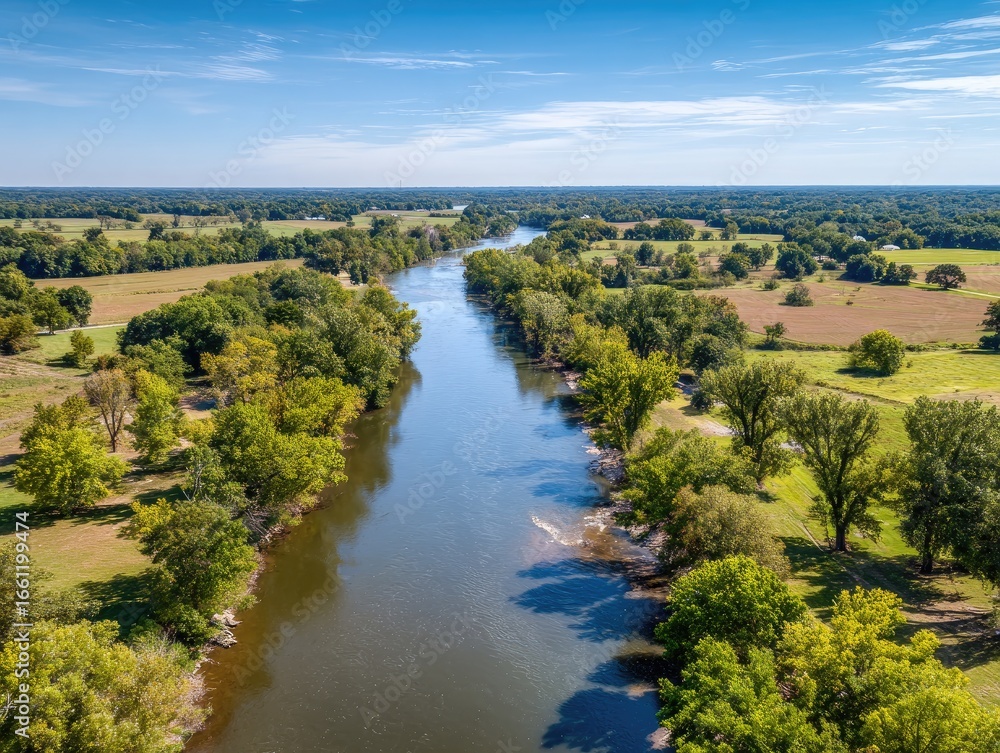 Obraz premium Scenic river winding through farmland
