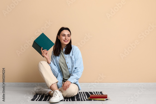 Young woman sitting on floo...
