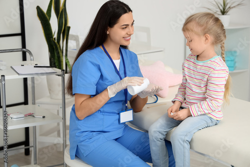 Female pediatrician giving ...
