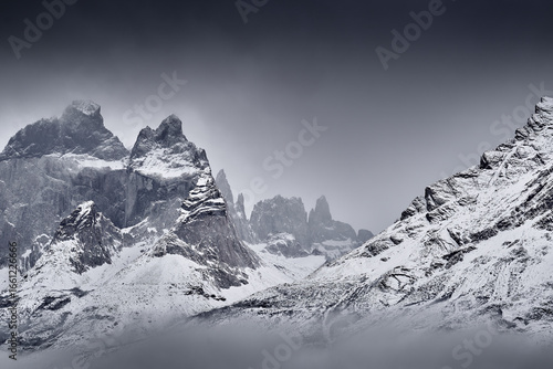 Winter fog twilight lanscape from Patagonia moutains with snow. Lago Nordenskjold, Torres del Paine National Park, Chile. Pink blue evening sky. Traveling in Chile,  hills in Torres del Paine NP.