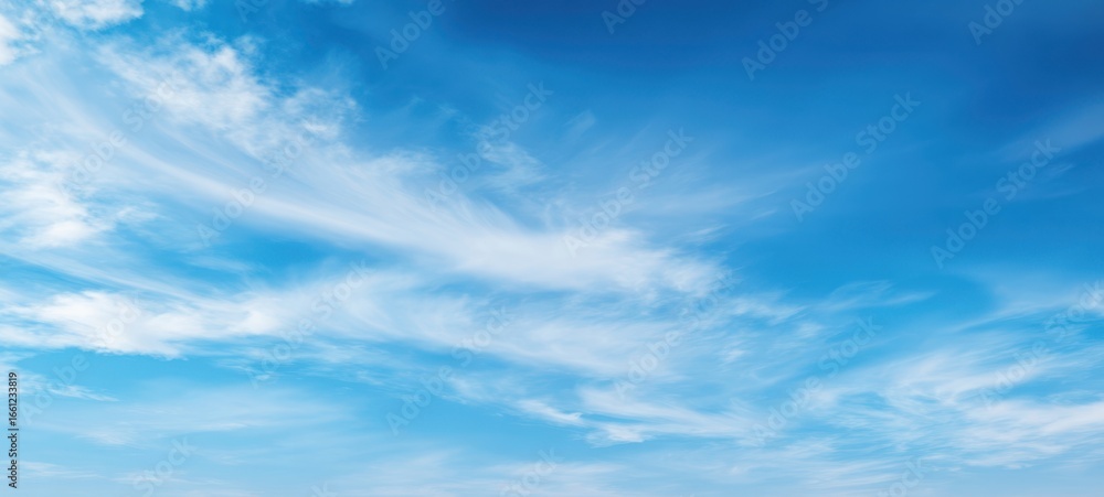 The Expansive Blue Sky Featuring Soft, Fluffy Clouds on a Clear Day The Expansive Blue Sky Featuring Soft, Fluffy Clouds on a Clear Day