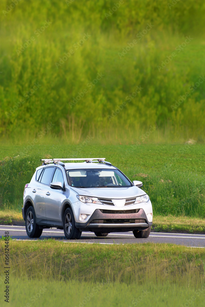 Fototapeta premium Sport utility vehicle driving on country road