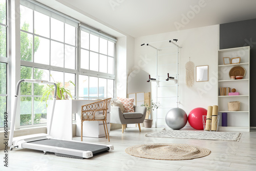 Interior of gym with modern sports equipment