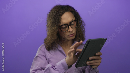 Wallpaper Mural Transgender woman holding a tablet places her finger to lips for silence in a vibrant purple studio; quiet calm. Torontodigital.ca