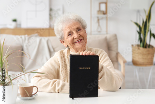 Senior woman with Bible sit...