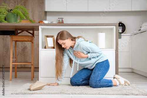 Young woman having panic attack in kitchen