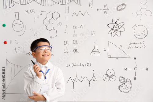 Cute little boy near whiteb...