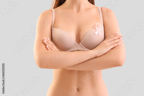 Young woman in bra with pin...