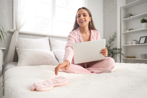 Young pretty woman in pajam...