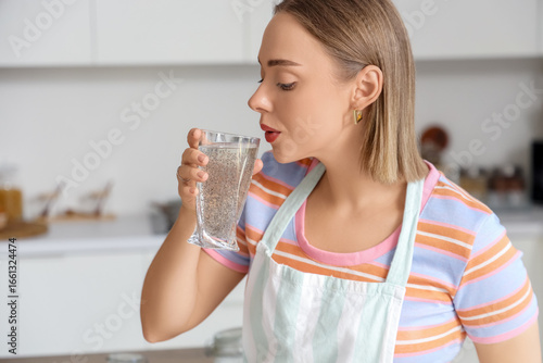 Young woman drinking water ...