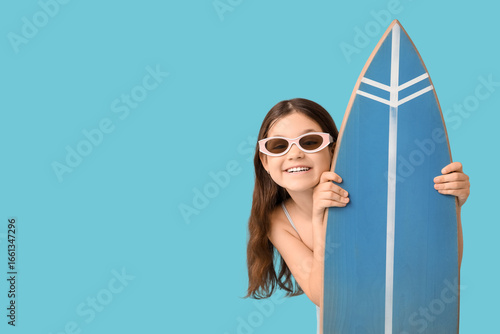 Happy girl with surfboard o...