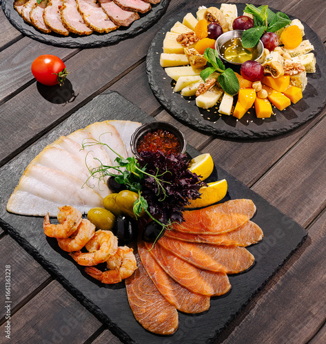 Gourmet charcuterie and seafood platter served on slate board
