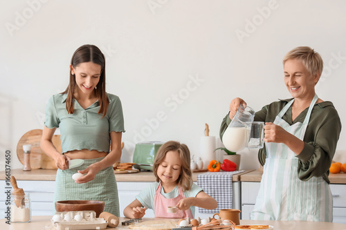 family bonding and home cooking, three generations of women baking together i...