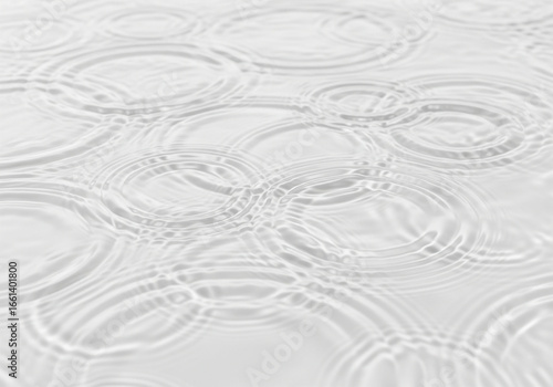 Clear water surface with delicate ripples forming concentric circles. This clean, minimalist background offers a pure and calming aesthetic for various creative projects.