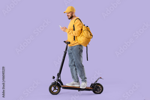 Young man riding electric k...