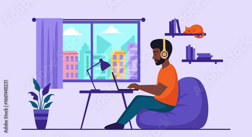Focused man works remotely on laptop with headphones from a comfortable home office, overlooking a city. Modern business, flexible lifestyle, and productivity.