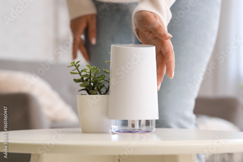 Woman with air humidifier o...