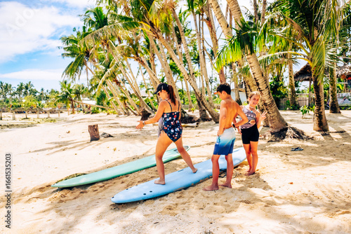 Family surfing in Cloud 9 beach, Siargao Island, Philippines