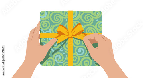 Hands hold a patterned gift box tied with a yellow ribbon  bow against a white backdrop