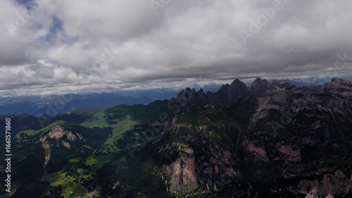 Dynamic drone spiral over Seceda ridges and valleys in the Dolomites, Italy