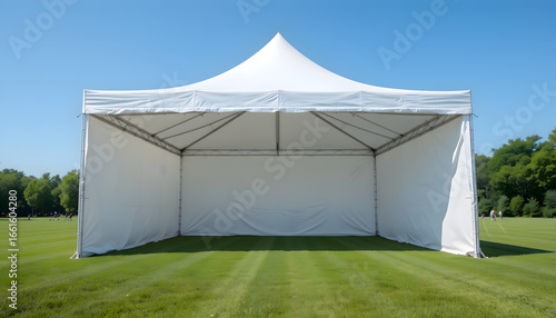 White Tent on Grassy Lawn Under Blue Sky for Outdoor Event